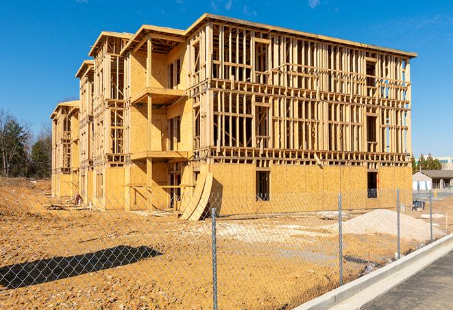 a temporary chain link fence in front of a building under construction, ensuring public safety in Pleasant View, TN